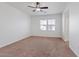 Bright bedroom with neutral carpet, window, and ceiling fan at 11428 Belmont Lake Dr # 104, Las Vegas, NV 89135