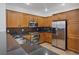 Modern kitchen featuring stainless steel appliances, dark countertops, and wooden cabinetry at 11428 Belmont Lake Dr # 104, Las Vegas, NV 89135