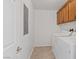Laundry room with front loading washer and dryer and cabinets for extra storage at 11428 Belmont Lake Dr # 104, Las Vegas, NV 89135
