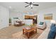 Bright living room featuring neutral furniture, tile flooring, and an open layout to the kitchen at 11428 Belmont Lake Dr # 104, Las Vegas, NV 89135