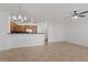 Bright open-concept space with tile flooring, kitchen bar, and a ceiling fan at 11428 Belmont Lake Dr # 104, Las Vegas, NV 89135