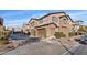 A row of townhomes with two-car garages and manicured landscaping in a well-maintained neighborhood at 11428 Belmont Lake Dr # 104, Las Vegas, NV 89135
