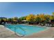 Inviting community swimming pool surrounded by lounge chairs and well maintained landscaping at 11428 Belmont Lake Dr # 104, Las Vegas, NV 89135