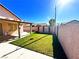 Spacious backyard featuring a covered patio and lush lawn, perfect for outdoor activities at 1269 Honey Lake St, Las Vegas, NV 89110