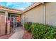 Charming front entrance decorated for fall with a metal gate and green bushes at 128 Painted Valley St, Henderson, NV 89074