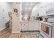 Bright kitchen featuring white cabinetry, appliances, and hardwood style flooring at 128 Painted Valley St, Henderson, NV 89074