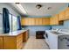 Spacious laundry room featuring blue walls, bright lighting, lots of cabinet and counter space, and a window at 1295 S Tenaya Way, Las Vegas, NV 89117