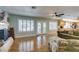 Open-concept living room with hardwood floors, a fireplace, and bright natural light at 1295 S Tenaya Way, Las Vegas, NV 89117