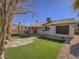 Beautiful backyard featuring a lush lawn, covered patio, and well-maintained landscaping at 1402 Bareback Ct, Henderson, NV 89014