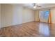 A bright and airy bedroom with wood floors and large window allowing for natural light at 1402 Bareback Ct, Henderson, NV 89014