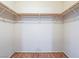 Empty walk-in closet with wooden rods for ample storage at 1402 Bareback Ct, Henderson, NV 89014
