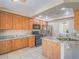 Well-equipped kitchen features wood cabinetry, stainless steel appliances, and granite countertops at 1402 Bareback Ct, Henderson, NV 89014