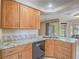 Kitchen with wood cabinets, granite counters, and a view of the backyard at 1402 Bareback Ct, Henderson, NV 89014
