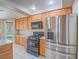 Kitchen featuring stainless steel appliances, granite counters and wood cabinets at 1402 Bareback Ct, Henderson, NV 89014