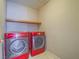 Well lit laundry room featuring modern appliances, and tiled flooring at 1402 Bareback Ct, Henderson, NV 89014