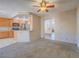 Bright living room featuring open floor plan, kitchen access, and neutral carpeting at 1402 Bareback Ct, Henderson, NV 89014