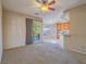 A spacious living room features carpet flooring and sliding door access to the outdoor patio at 1402 Bareback Ct, Henderson, NV 89014