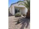 Charming backyard featuring a covered patio, mature palm trees, and low-maintenance landscaping at 2341 Celestial Moon St, Henderson, NV 89044