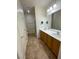 Well-lit bathroom featuring a double sink vanity, large mirror and tiled floor at 2341 Celestial Moon St, Henderson, NV 89044