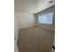 Bright, carpeted bedroom with a window and neutral walls at 2341 Celestial Moon St, Henderson, NV 89044