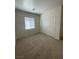 Neutral bedroom featuring plush carpeting, a window with blinds, and a spacious closet at 2341 Celestial Moon St, Henderson, NV 89044