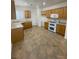 Open kitchen featuring tiled flooring, wooden cabinets, and white appliances at 2341 Celestial Moon St, Henderson, NV 89044