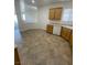 Bright kitchen with tiled flooring, wood cabinets, and white appliances at 2341 Celestial Moon St, Henderson, NV 89044
