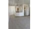 Living room with carpeted floors and kitchen with tile floors at 2341 Celestial Moon St, Henderson, NV 89044