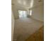 Spacious living room with carpet, sliding glass doors, and a bright airy feel from the natural light at 2341 Celestial Moon St, Henderson, NV 89044