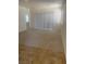 Carpeted living room adjacent to kitchen with tile floors and a large window at 2341 Celestial Moon St, Henderson, NV 89044
