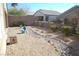 Desert-landscaped backyard with rock features, fencing, and a bird house at 2601 Centaurus St, Henderson, NV 89044