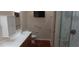 Bright bathroom featuring a vanity, storage, a shower with glass doors, and grab bars at 2601 Centaurus St, Henderson, NV 89044