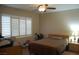 This bedroom has plantation shutters, a ceiling fan, and wood-look floors at 2601 Centaurus St, Henderson, NV 89044