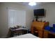 Bedroom features a window, shutters, and a study desk with a TV at 2601 Centaurus St, Henderson, NV 89044