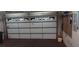 Well lit two car garage with an epoxy floor, tools, and a work bench at 2601 Centaurus St, Henderson, NV 89044