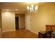 This living room has wood-look flooring and chandelier-style light fixture at 2601 Centaurus St, Henderson, NV 89044