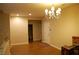 An open living area has wood-look flooring, and a chandelier-style light fixture at 2601 Centaurus St, Henderson, NV 89044