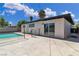 Back exterior view of the house features a pool, a patio area, and sliding glass doors at 2716 Salt Lake St, North Las Vegas, NV 89030