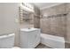 Neat bathroom with a tiled shower-tub combo, a white vanity, and modern fixtures at 2716 Salt Lake St, North Las Vegas, NV 89030