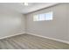 Minimalist bedroom with hardwood flooring and a sunlit window, creating a serene space at 2716 Salt Lake St, North Las Vegas, NV 89030