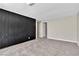 Open bedroom features neutral carpet and walls, along with a modern black accent wall at 2716 Salt Lake St, North Las Vegas, NV 89030