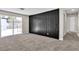 Spacious carpeted bedroom with modern black accent wall and sliding glass door to backyard at 2716 Salt Lake St, North Las Vegas, NV 89030