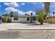 Charming single-story home featuring a xeriscaped front yard, mature shade trees, and a large driveway at 2716 Salt Lake St, North Las Vegas, NV 89030