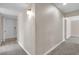 Hallway area features carpeted flooring, neutral walls, and easy access to the laundry room and other rooms at 2716 Salt Lake St, North Las Vegas, NV 89030