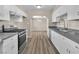Beautiful kitchen featuring modern stainless steel appliances, bright white cabinetry, and updated fixtures at 2716 Salt Lake St, North Las Vegas, NV 89030