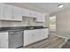 Bright kitchen featuring white cabinets, stainless steel appliances, and a gray countertop at 2716 Salt Lake St, North Las Vegas, NV 89030