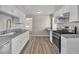 Updated kitchen features new stainless steel appliances, modern white cabinets, and beautiful countertops at 2716 Salt Lake St, North Las Vegas, NV 89030