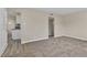 Spacious living room leading to kitchen, featuring plush carpeting and freshly painted interiors at 2716 Salt Lake St, North Las Vegas, NV 89030