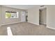 Comfortable living room with neutral carpeting, fresh paint, and ample natural light at 2716 Salt Lake St, North Las Vegas, NV 89030