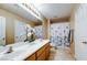 Bathroom featuring a double sink vanity with tile flooring and bright lighting at 283 Auster Park Ave, Las Vegas, NV 89148